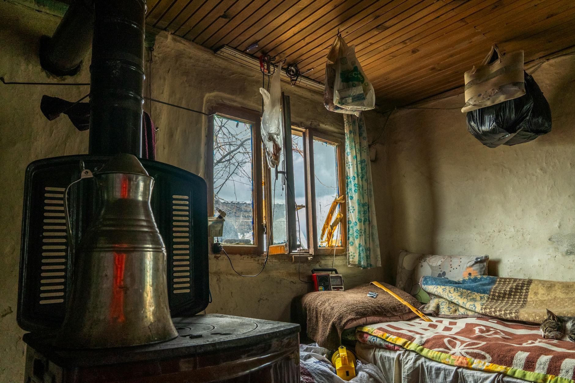 Modest guesthouse room with traditional furniture and crucifix on the wall