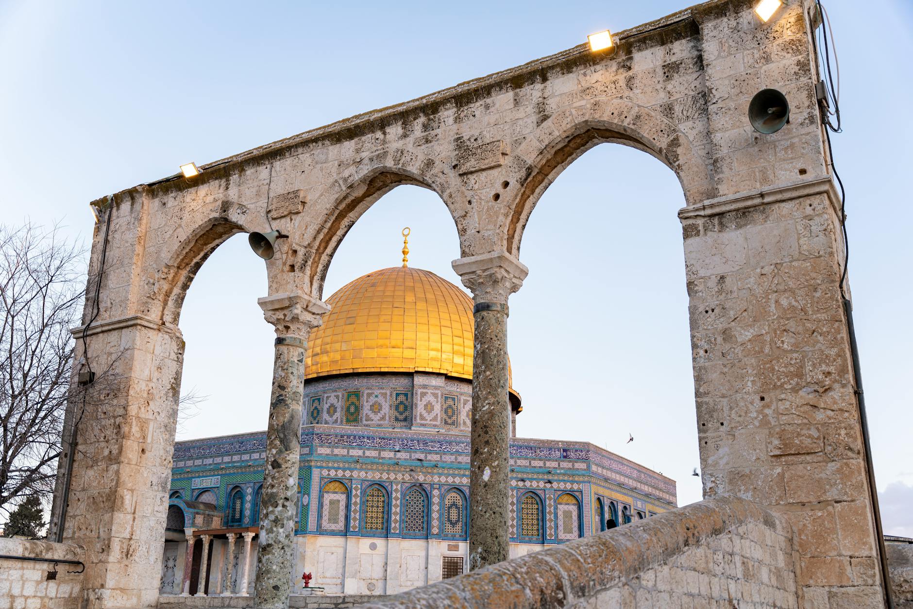Photographer capturing golden sunset over Jerusalem Old City with Dome of the Rock