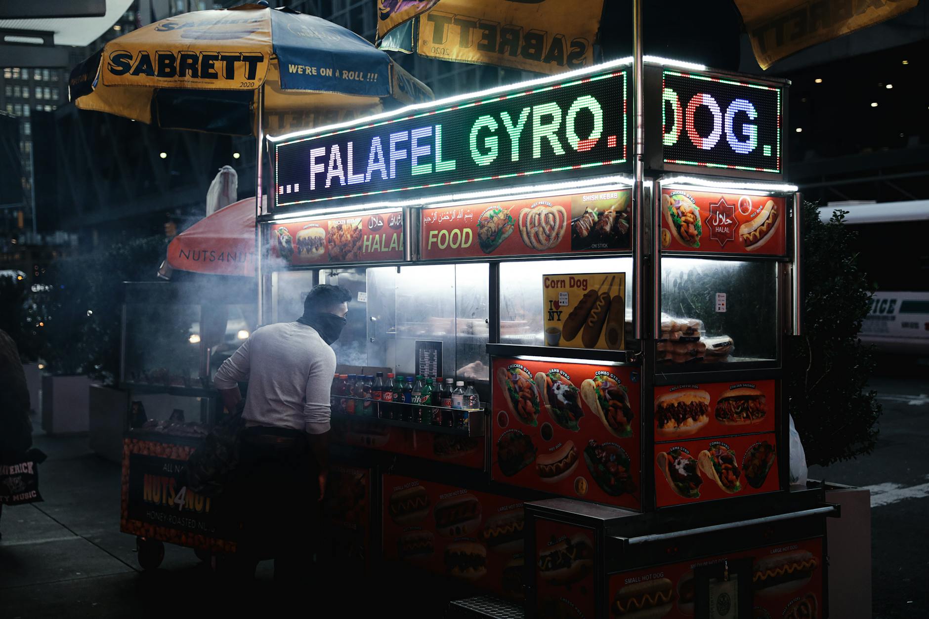 Jerusalem street food vendor preparing falafel and shawarma at a busy stall