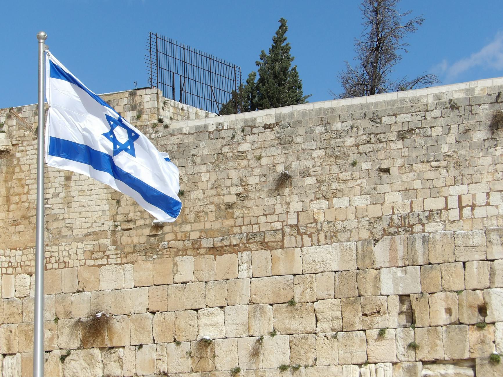The Western Wall in Jerusalem with worshippers praying at the ancient stones