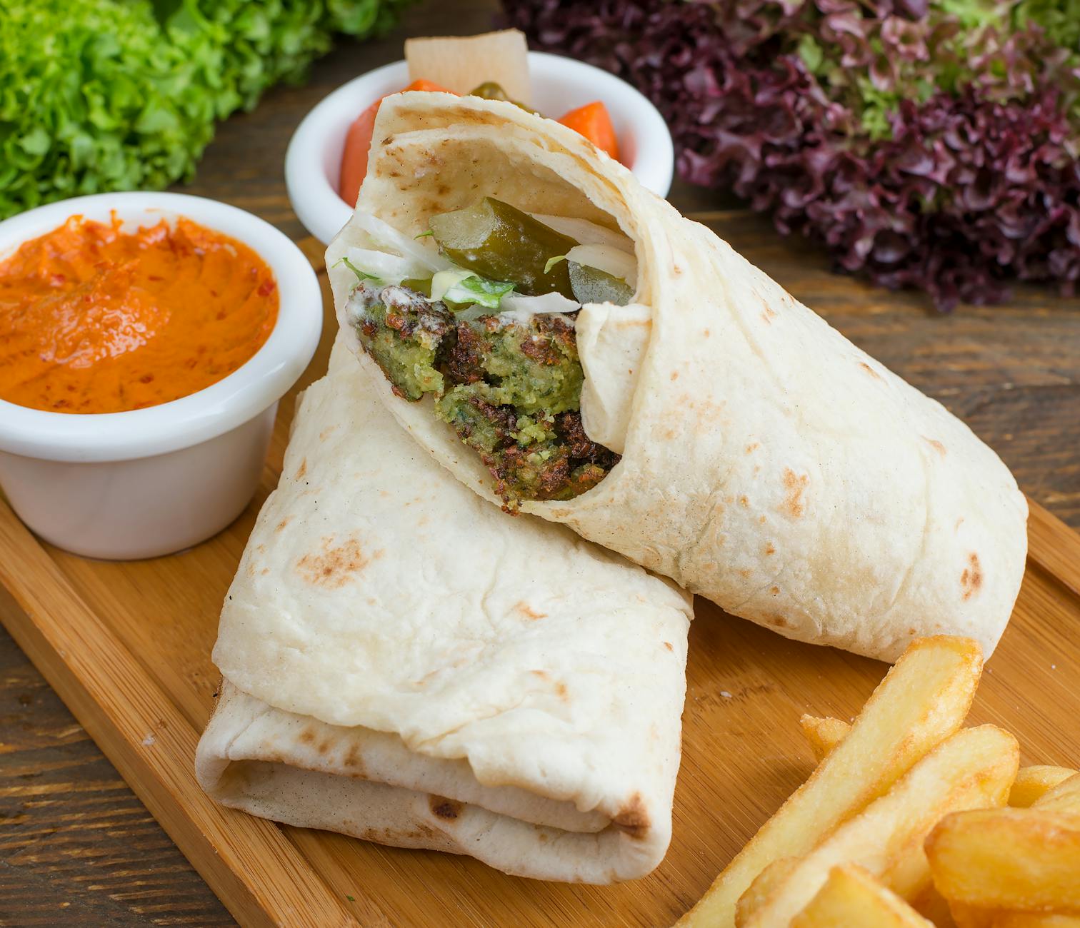 Affordable falafel wrap and hummus plate at a Jerusalem market