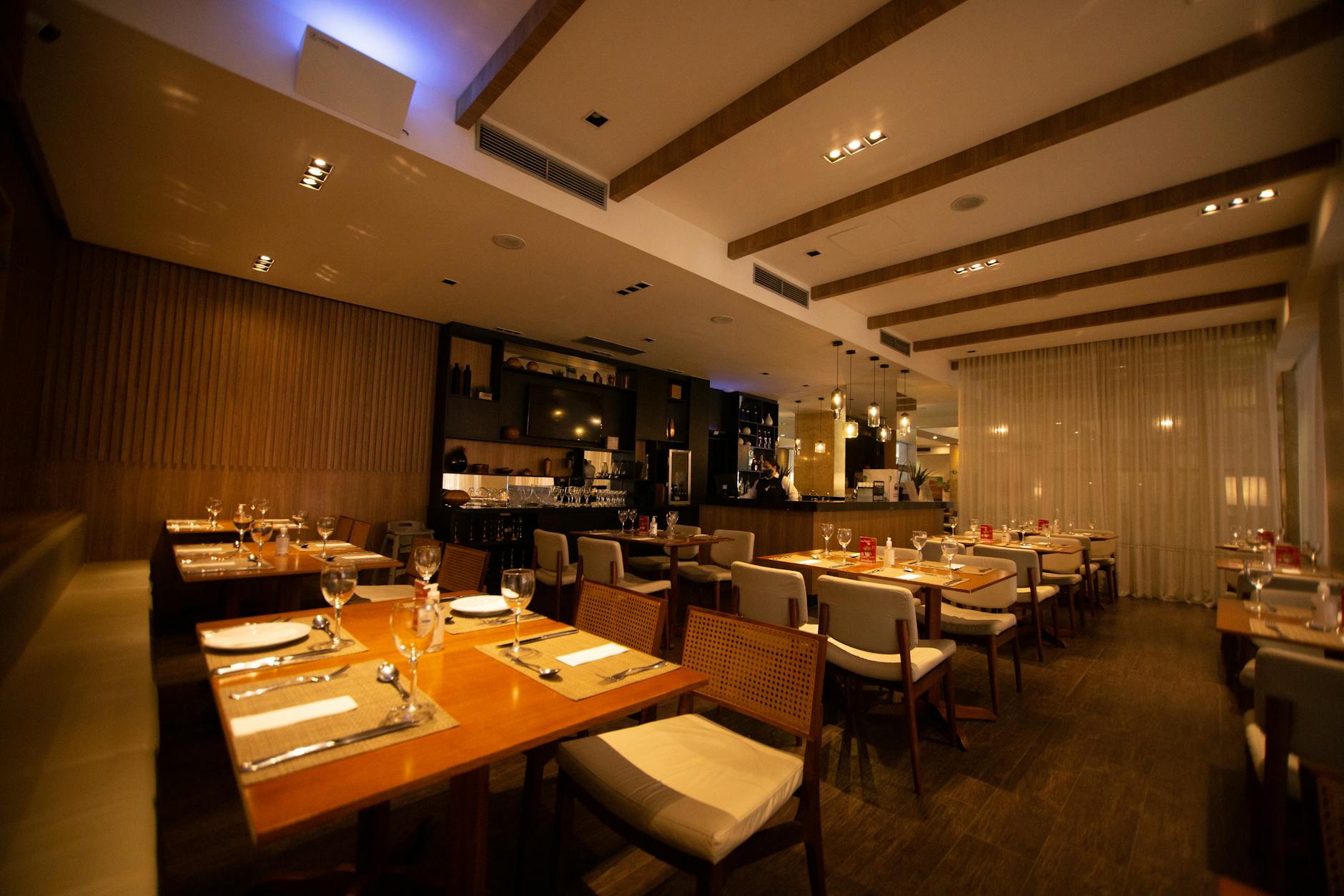 Upscale restaurant interior with elegant table settings and warm lighting