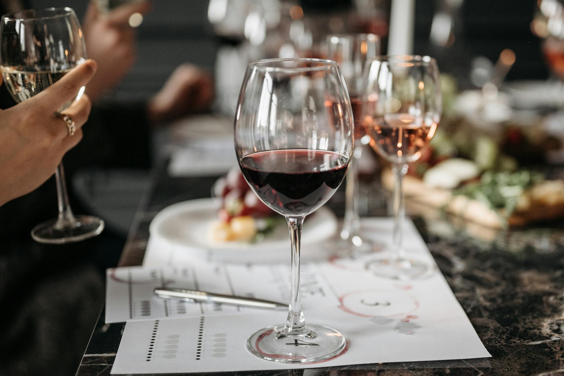 Elegant wine glasses and tasting menu dishes at a fine dining experience