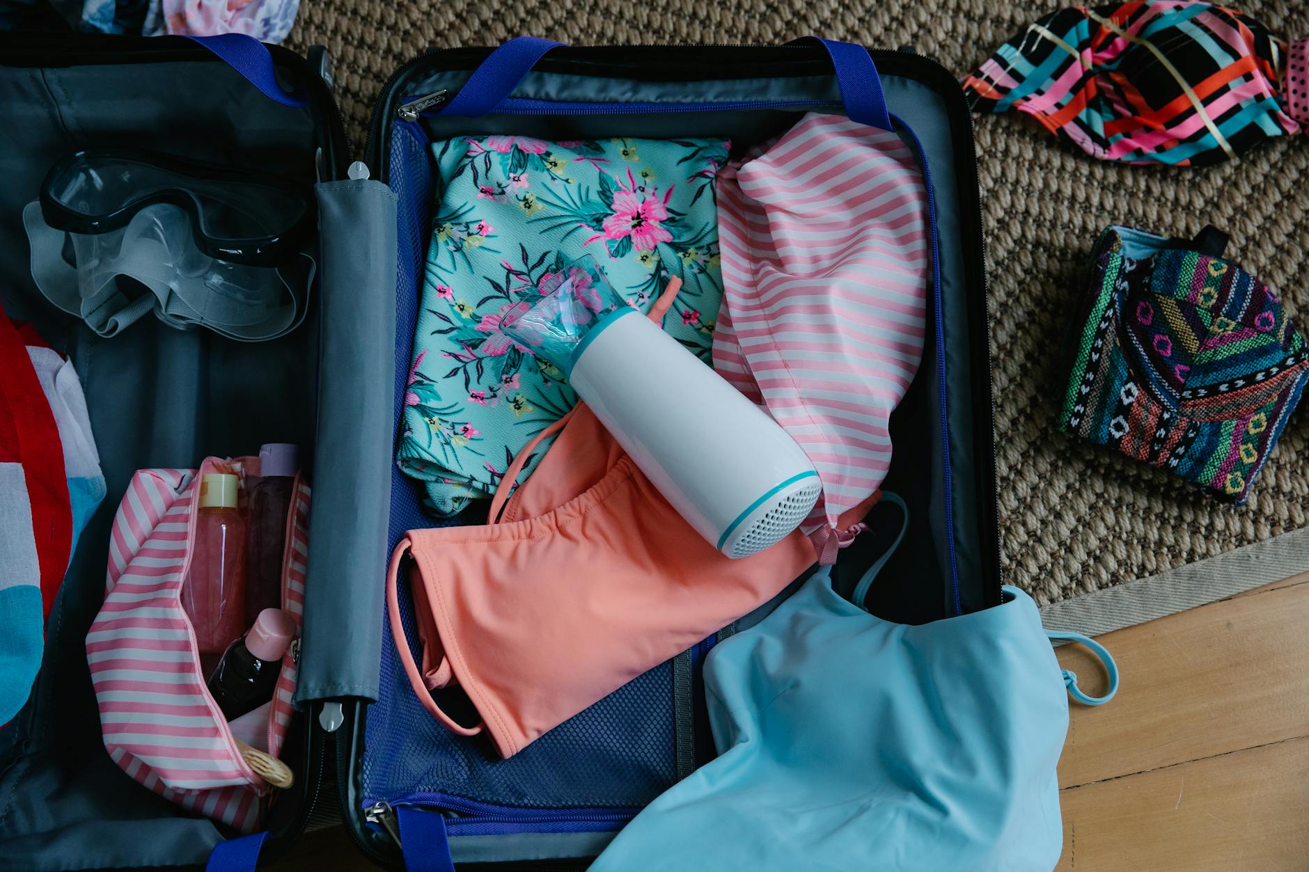 Travel essentials including water bottle, sunscreen, and walking shoes packed for Jerusalem