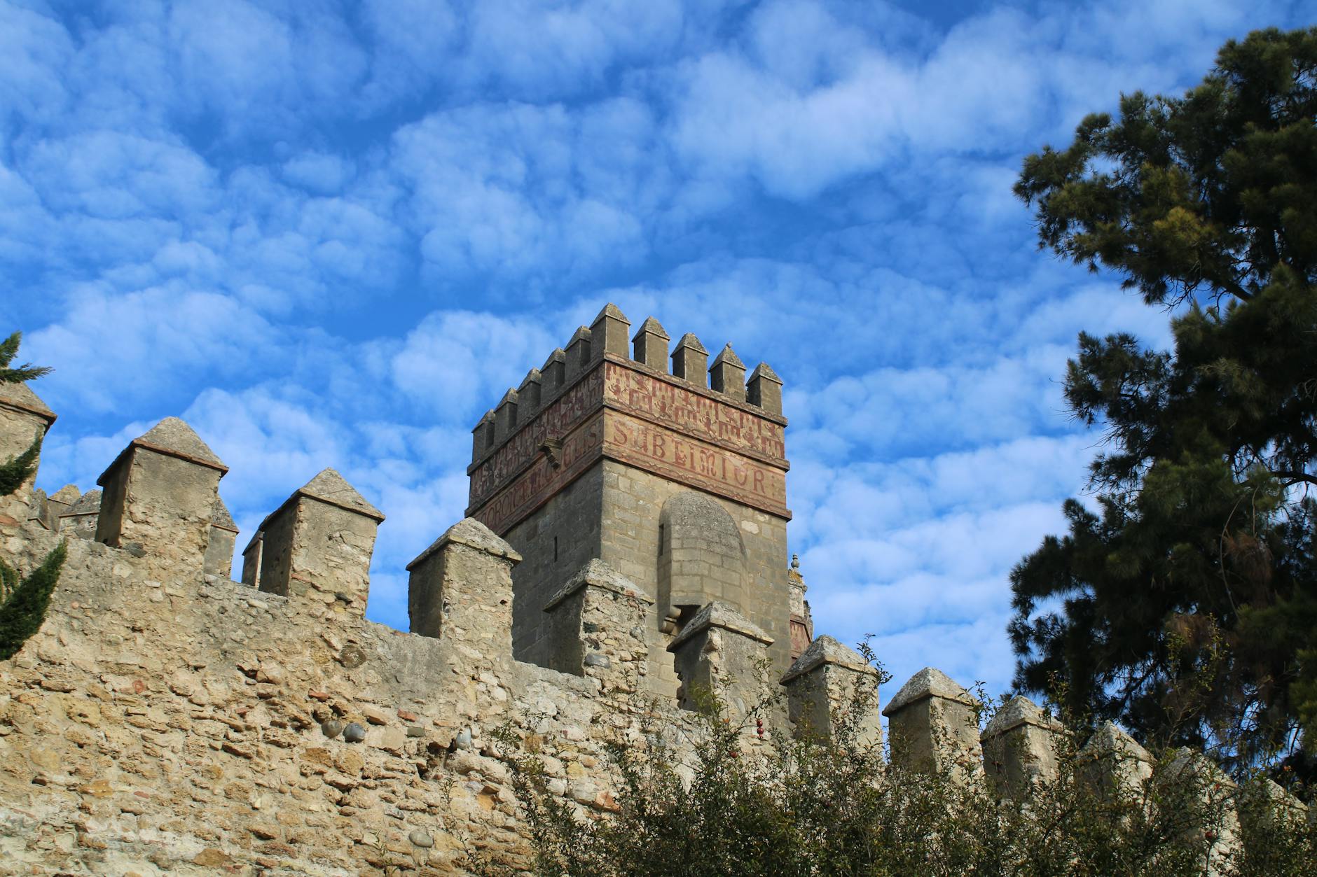 Stone path along Jerusalem Old City walls with Ottoman ramparts and crenellations