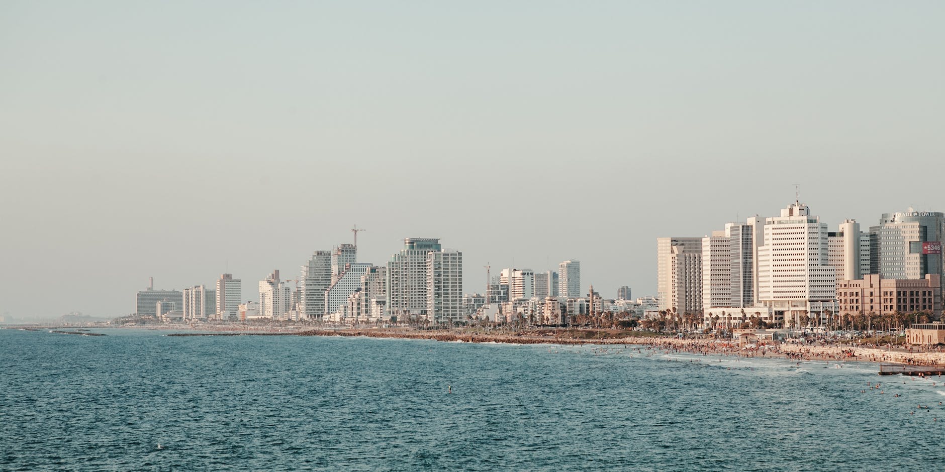 Tel Aviv beach with Mediterranean coast and modern skyline