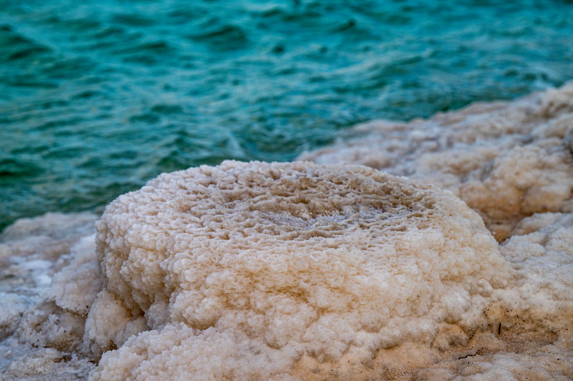Dead Sea coast with mountains and salt crystals near Masada