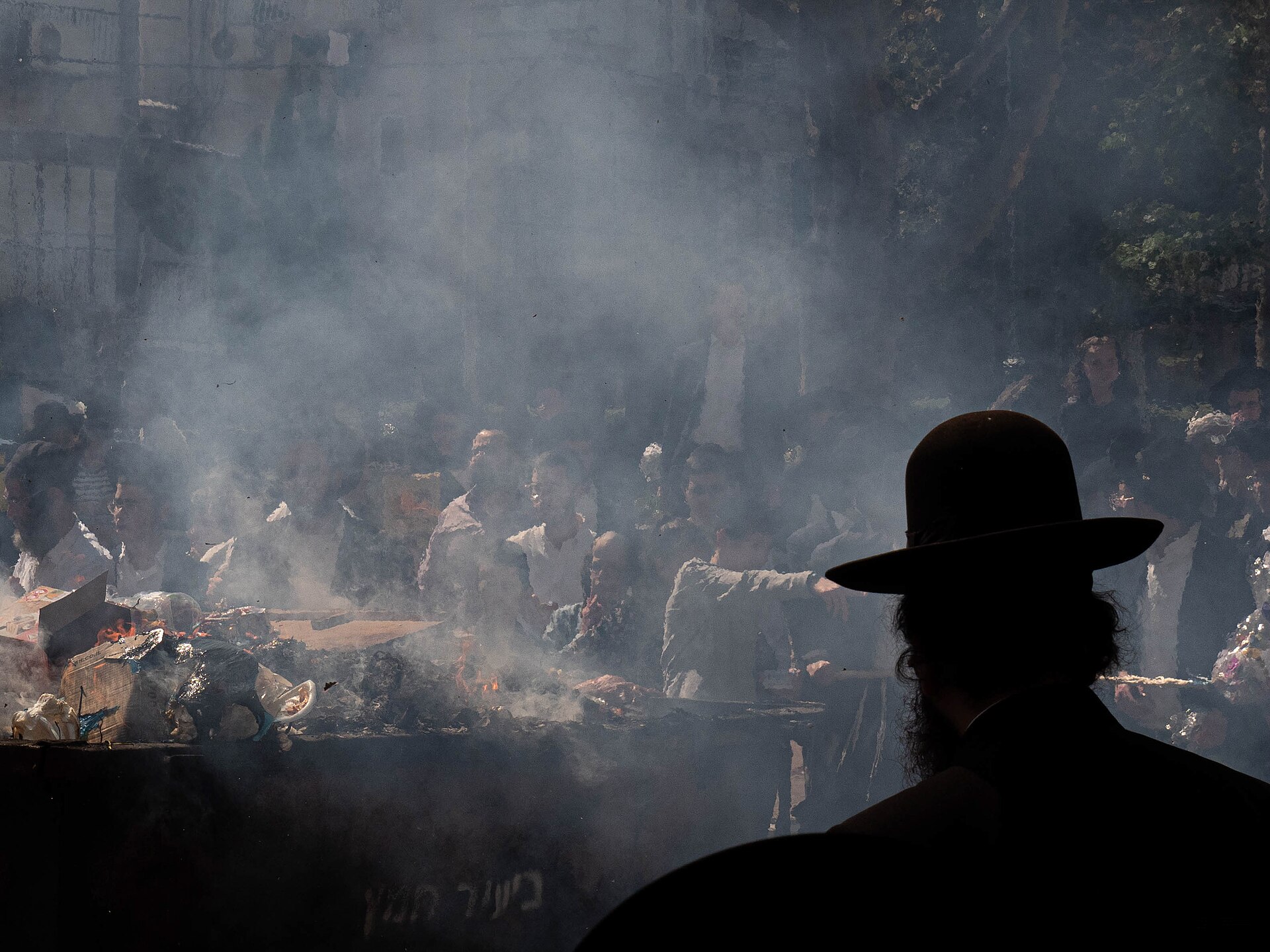 Smoke rising from a municipal skip as crowds burn leavened bread on the morning before Passover in Jerusalem