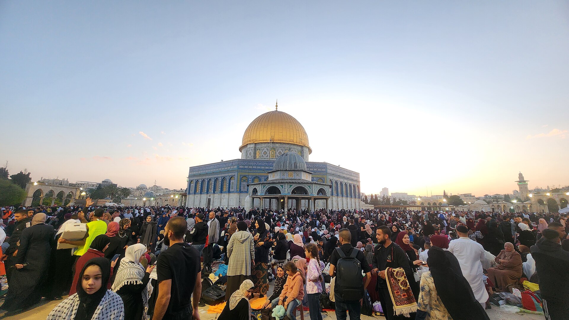 Crowds of Muslim families gathered on the Haram al-Sharif / Temple Mount esplanade in front of the Dome of the Rock at sunset during Ramadan