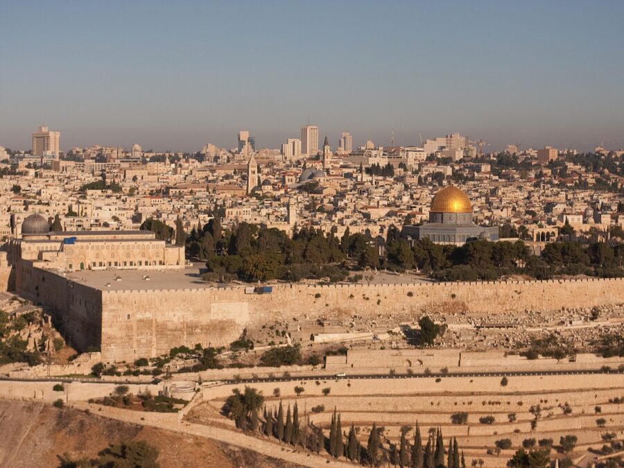 Early-morning sun lights Jerusalem's Old City from the Mount of Olives: the eastern walls, Al-Aqsa Mosque and the golden Dome of the Rock above terraced slopes