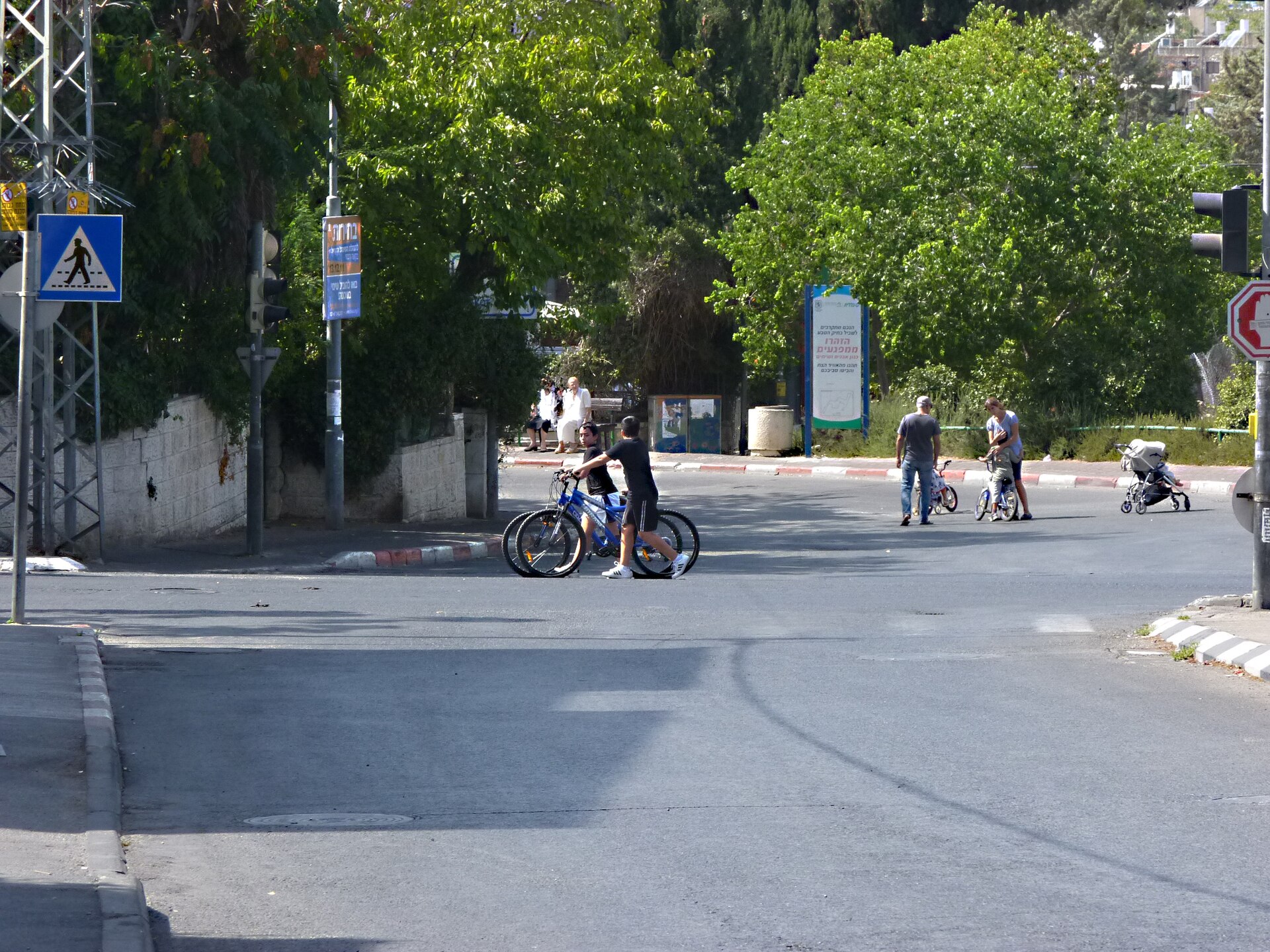 Children with bicycles standing in the middle of a completely empty road junction in Jerusalem on Yom Kippur