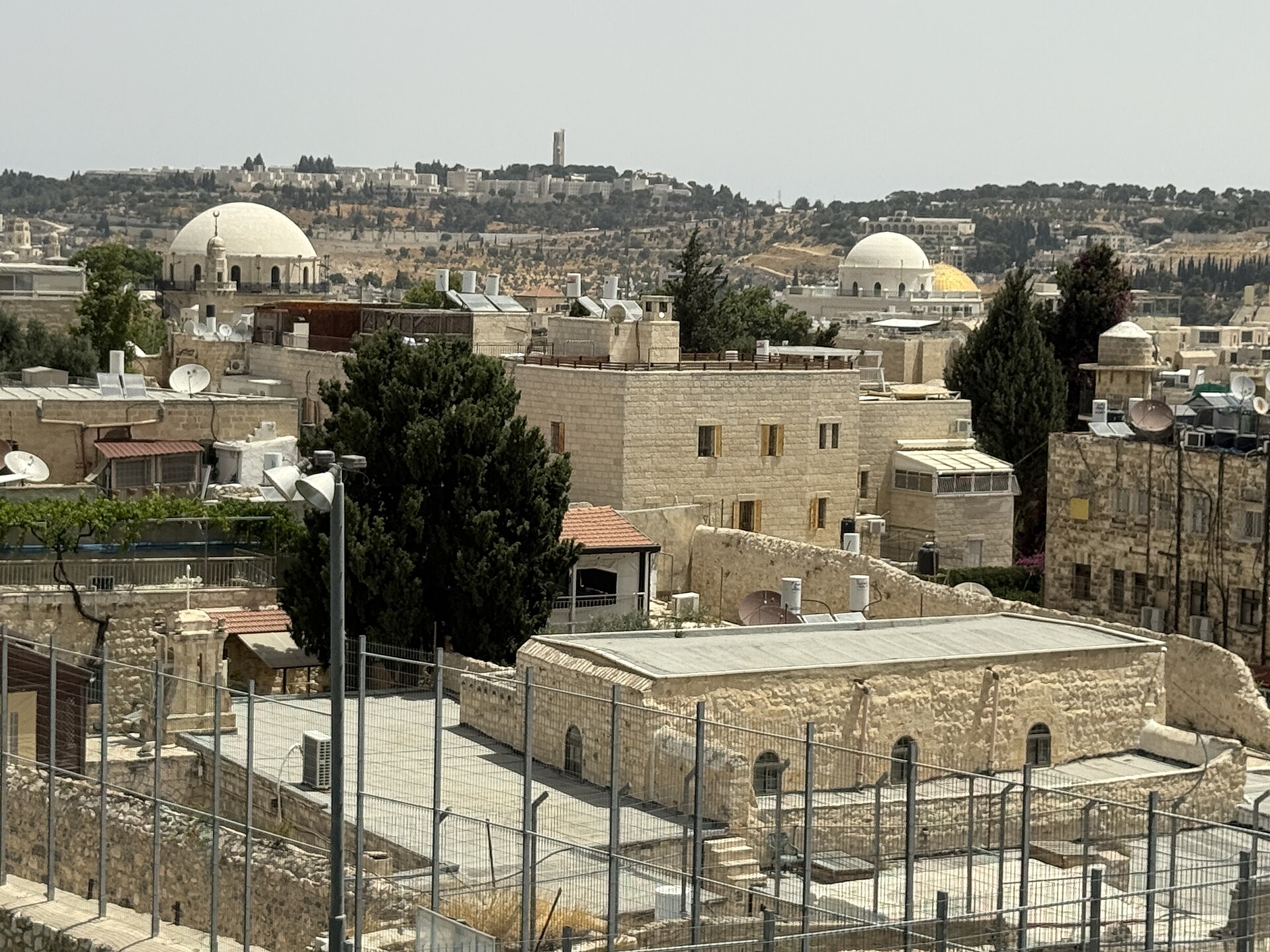 Jewish Quarter rooftops seen from the southern Ramparts Walk, with the white dome of the Hurva Synagogue, a minaret and the golden Dome of the Rock beyond