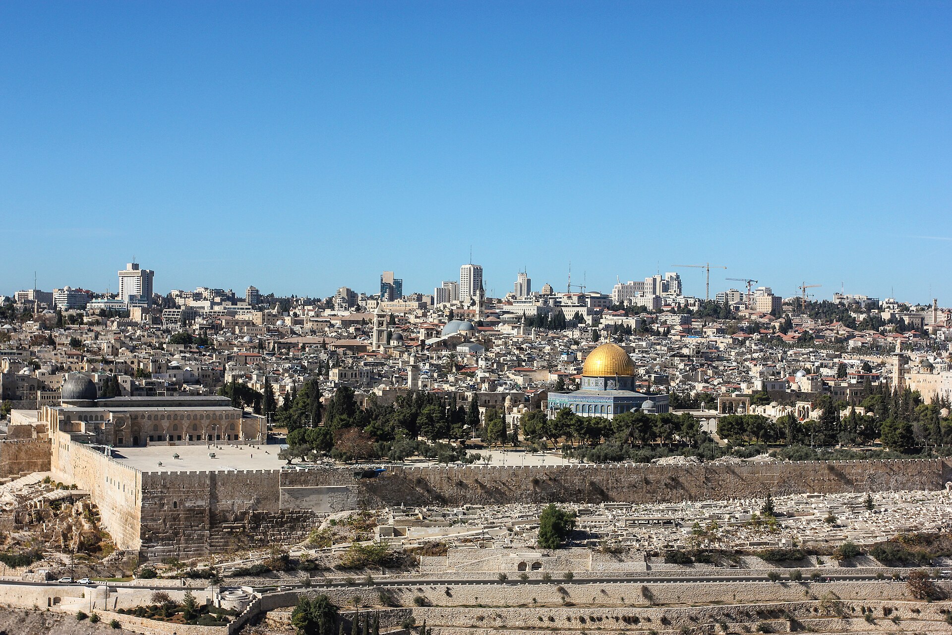 Panorama from the Mount of Olives of the Old City walls, Al-Aqsa Mosque and the golden Dome of the Rock under a clear blue sky