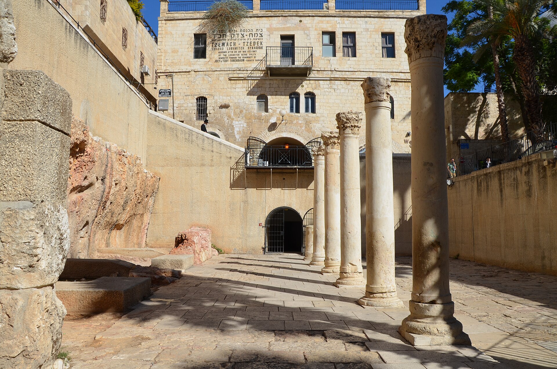 Re-erected stone columns with Corinthian capitals line the excavated Cardo in Jerusalem's Jewish Quarter, below the Tzemach Tzedek synagogue building