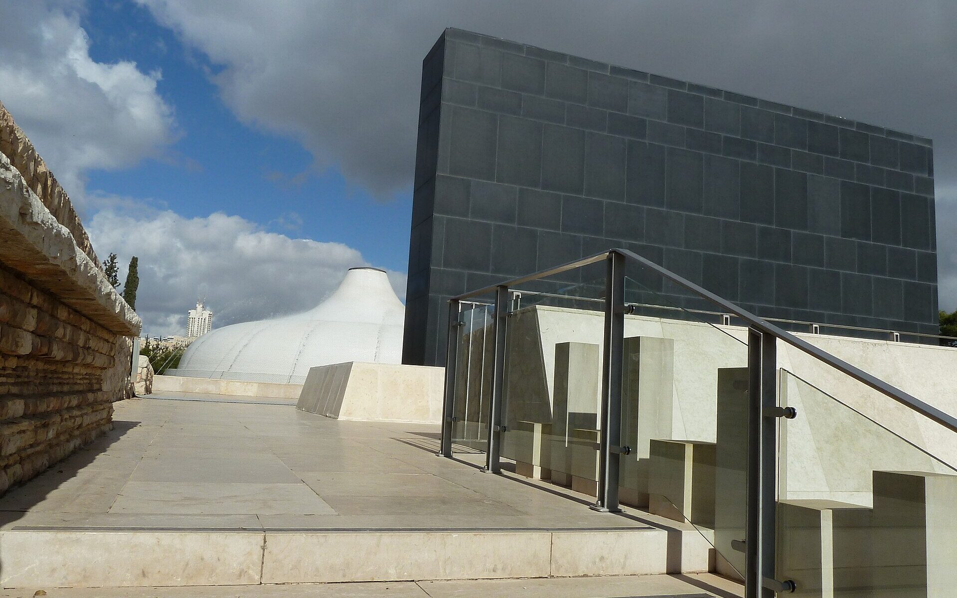 The white dome of the Shrine of the Book beside its black basalt wall at the Israel Museum in Jerusalem