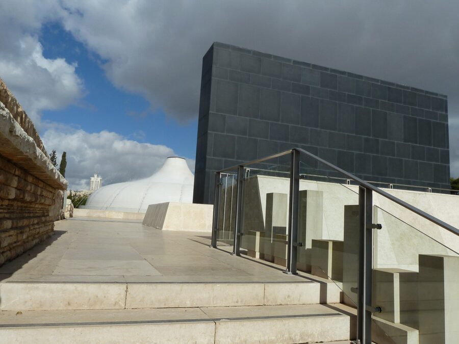 The white dome of the Shrine of the Book beside its black basalt wall at the Israel Museum in Jerusalem