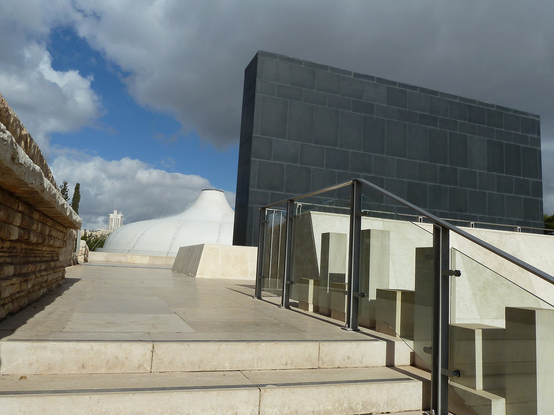 The white dome of the Shrine of the Book beside its black basalt wall at the Israel Museum in Jerusalem
