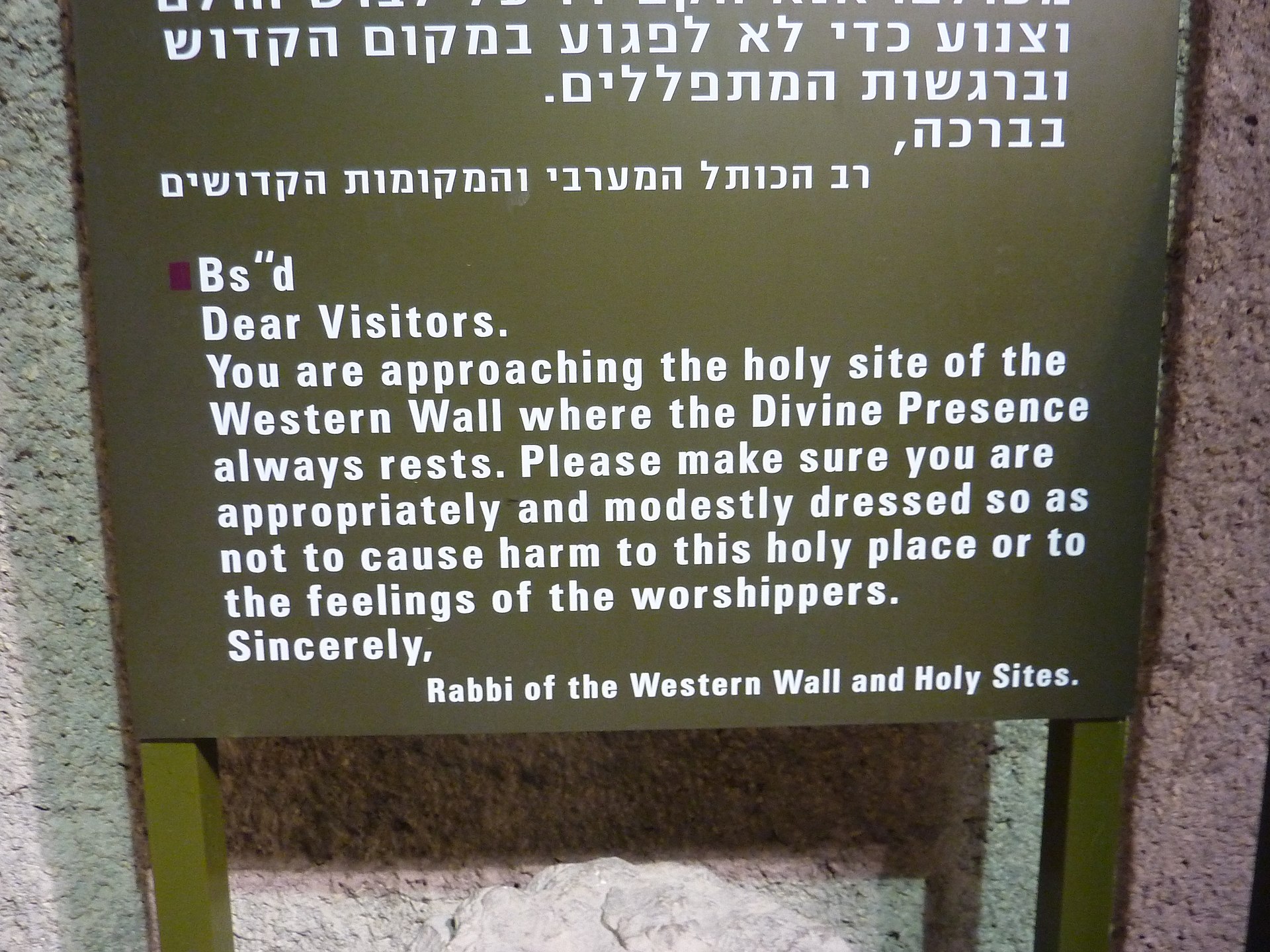 Sign in Hebrew and English at the Western Wall asking visitors to be appropriately and modestly dressed, signed by the Rabbi of the Western Wall and Holy Sites