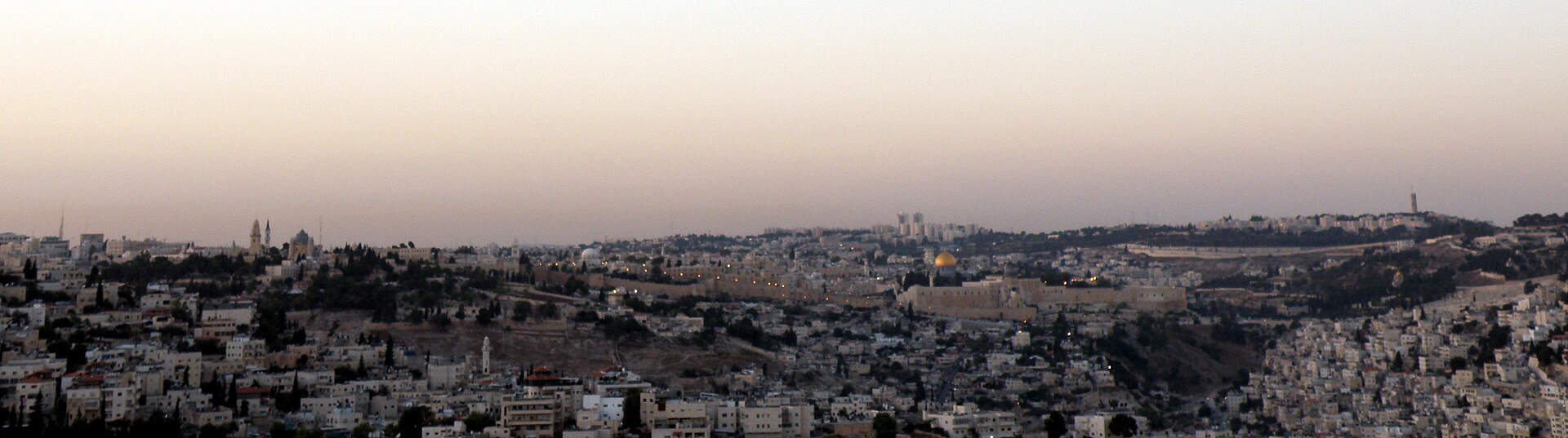 Sunset panorama from the Haas Promenade of Jerusalem's Old City walls and golden Dome of the Rock, with Mount Zion at left and the Mount of Olives at right