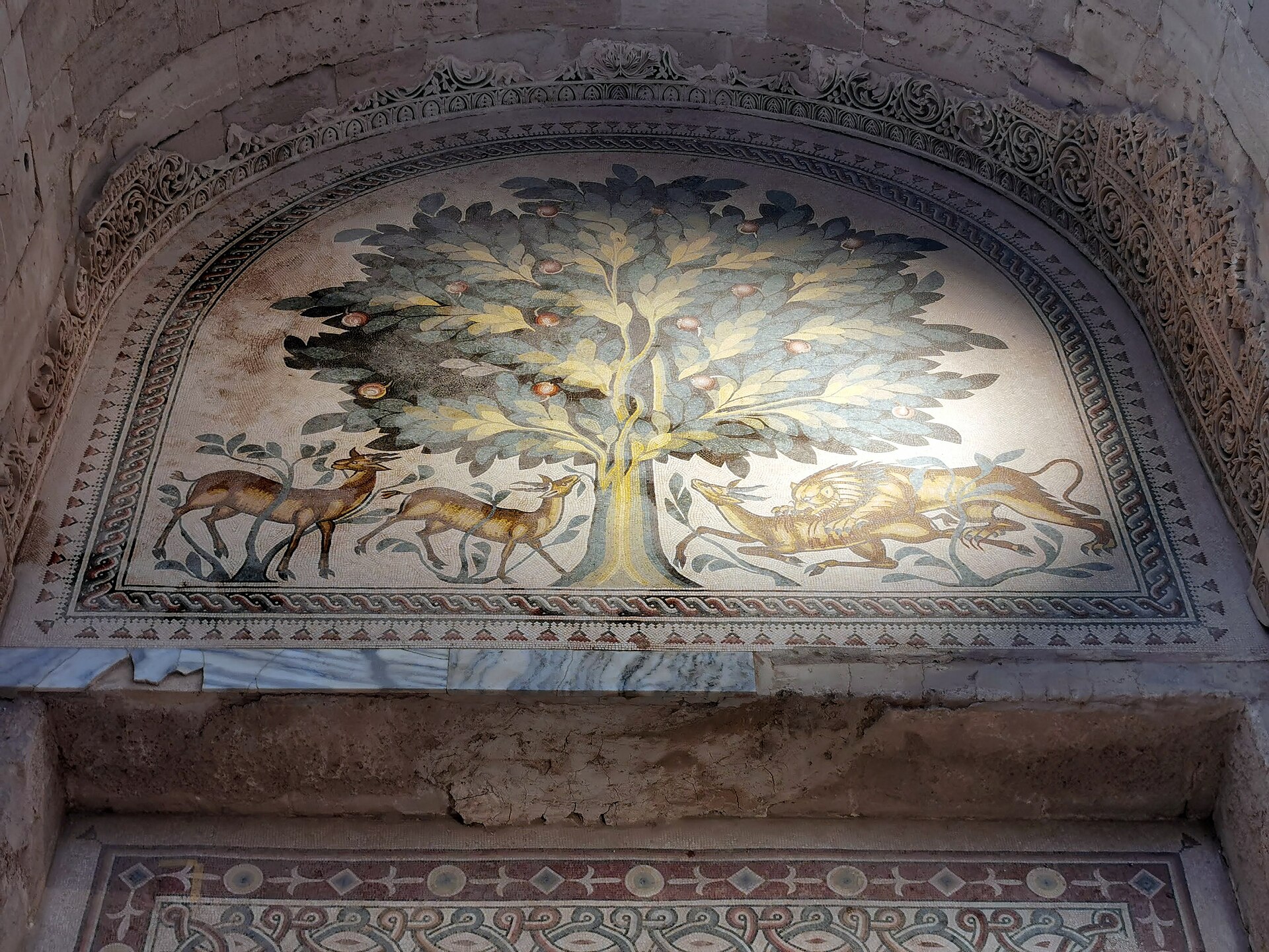 The Tree of Life mosaic at Hisham's Palace, Jericho: a fruit tree with two gazelles grazing on the left and a lion attacking a gazelle on the right